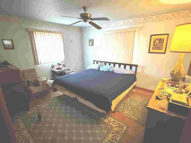 a bed sitting in a bedroom next to a window