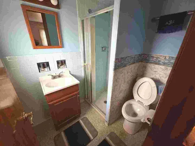 a bathroom with a sink mirror vanity and toilet