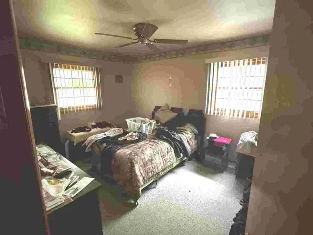 a bedroom with bed and window