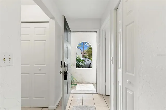 a view of kitchen with stainless steel appliances a large window and a fireplace