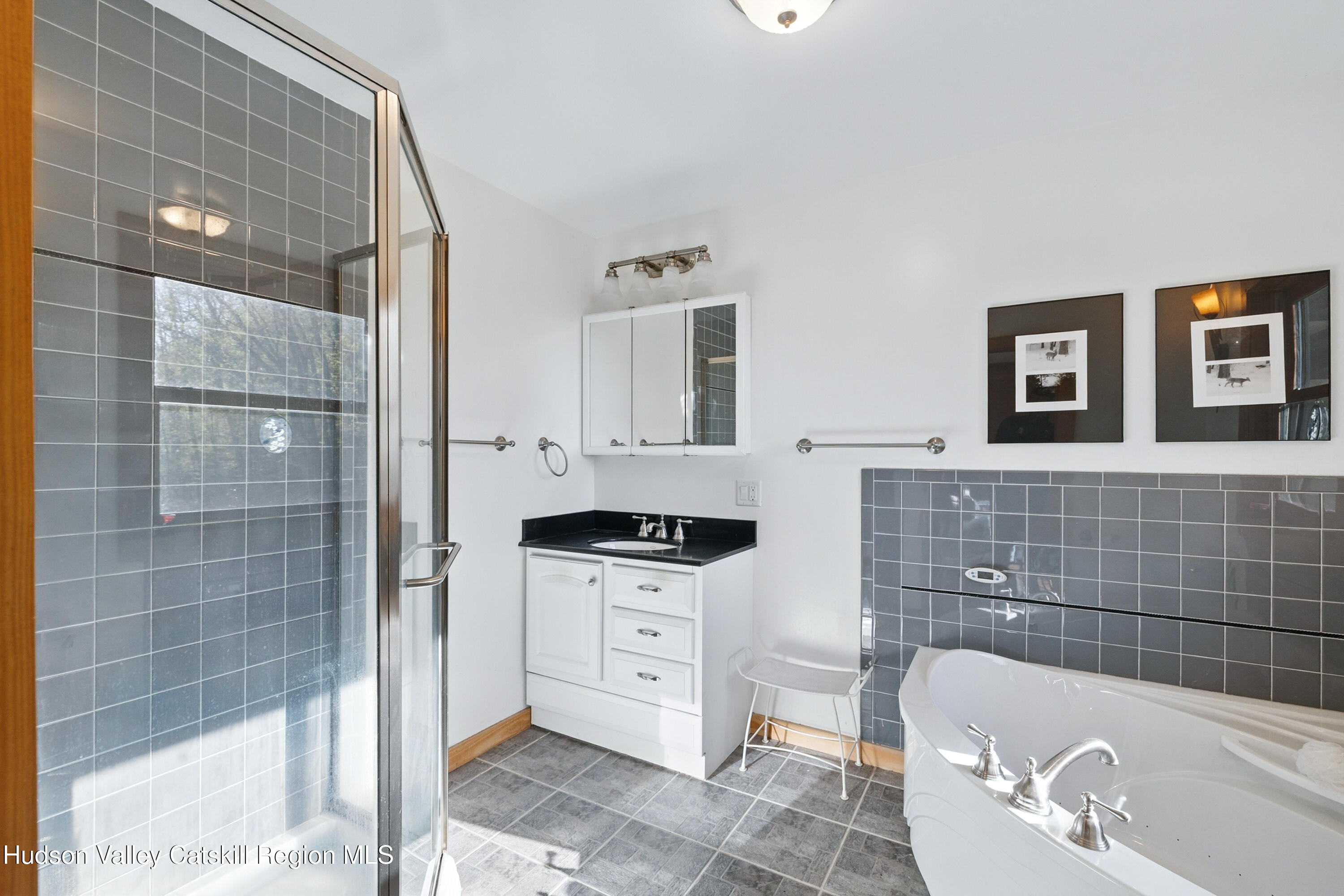 48 Hillside Drive West Shokan, NY 12494 - Photo 14 of 30 a bathroom with a sink a granite counter and a glass door shower