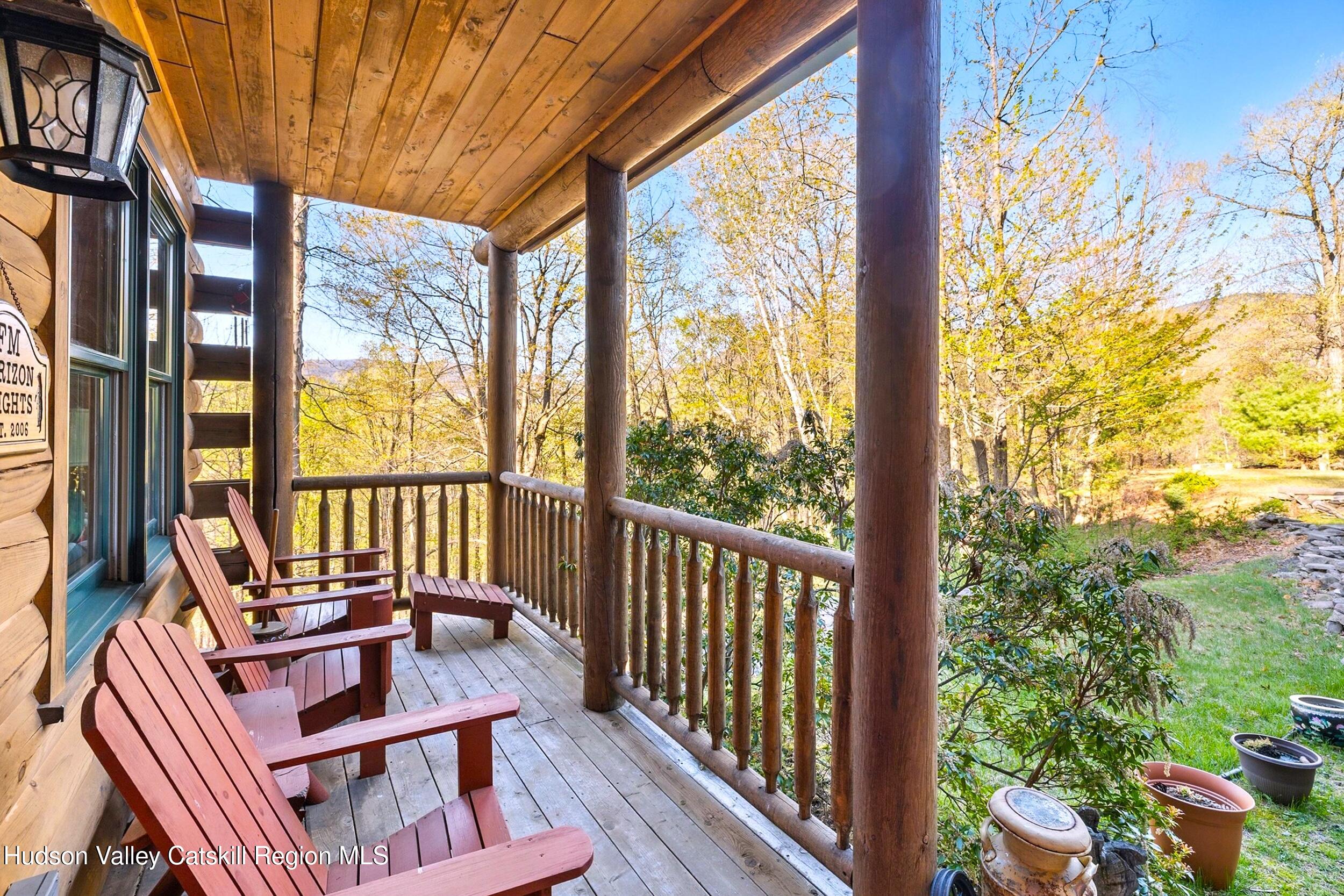 48 Hillside Drive West Shokan, NY 12494 - Photo 22 of 30 a view of a balcony with couch and wooden floor