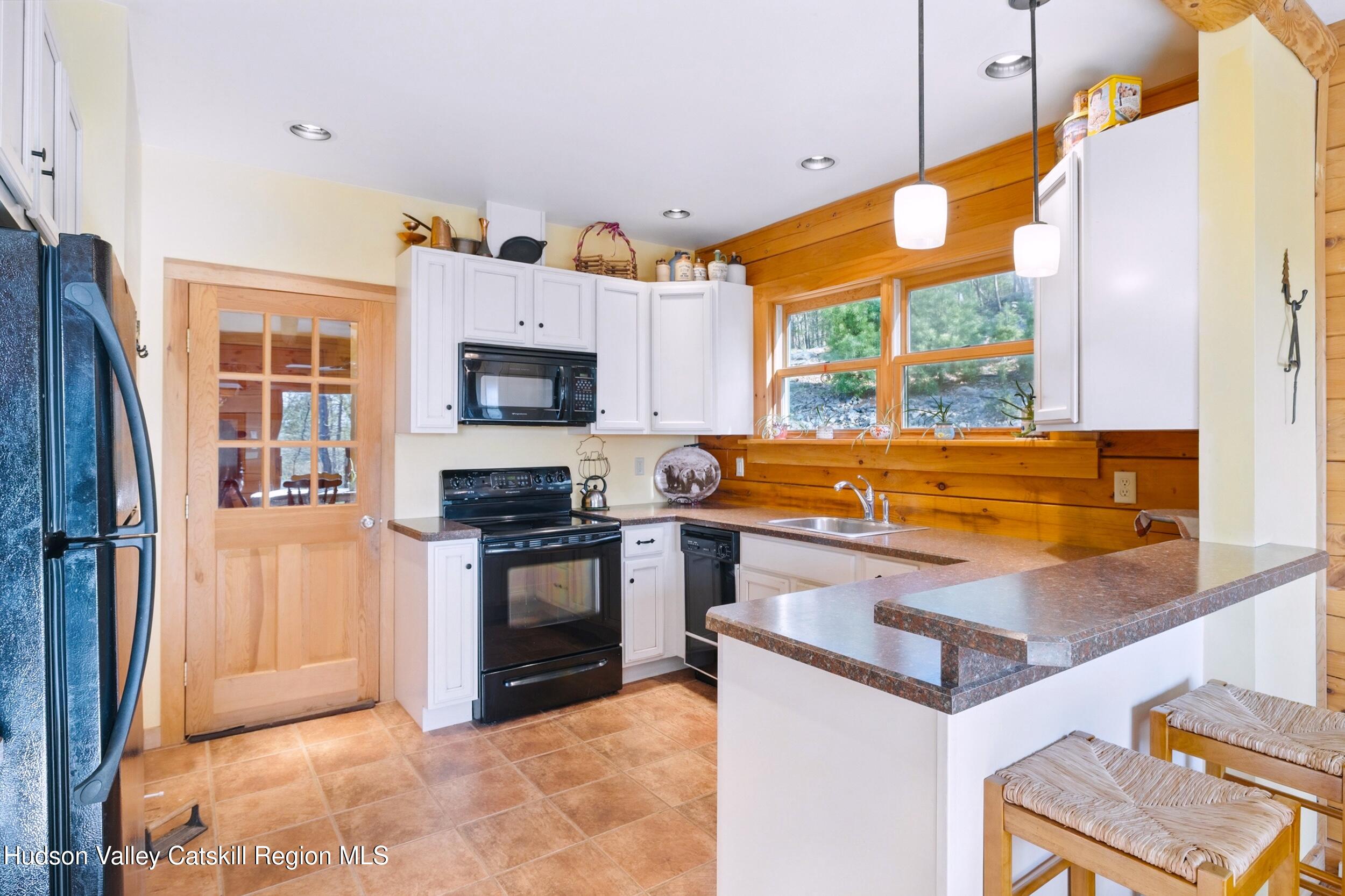 48 Hillside Drive West Shokan, NY 12494 - Photo 7 of 30 a kitchen with stainless steel appliances granite countertop a stove a sink and a refrigerator