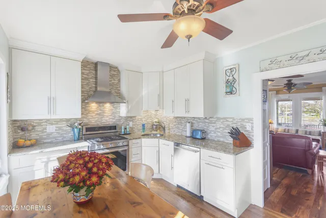 a kitchen with stainless steel appliances granite countertop a sink and cabinets