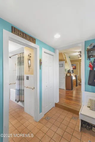 a view of a hallway view with wooden floor and living room