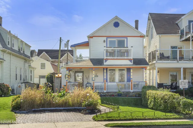 a front view of a residential apartment building with a yard