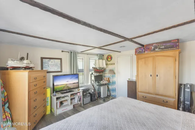 a bedroom with furniture and a flat tv screen
