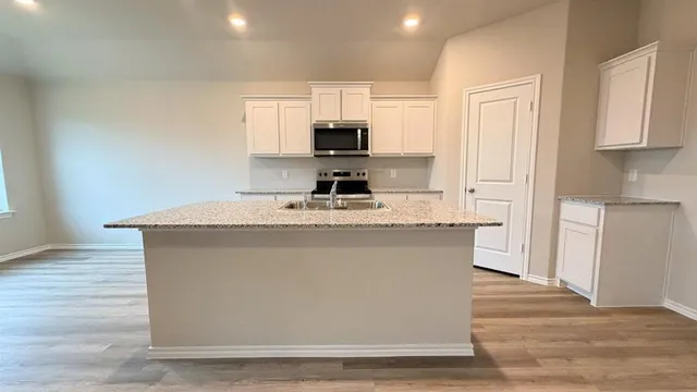 a view of a house with wooden fence