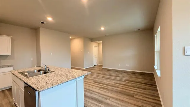 a kitchen with a sink microwave and refrigerator