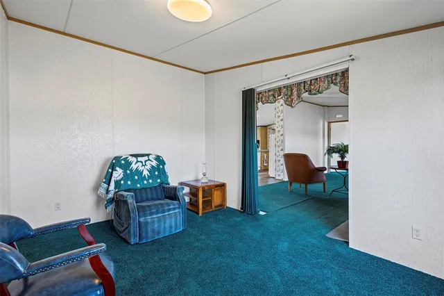 a living room with furniture and a dining table