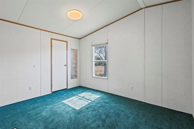 a view of a room with window and hardwood floor