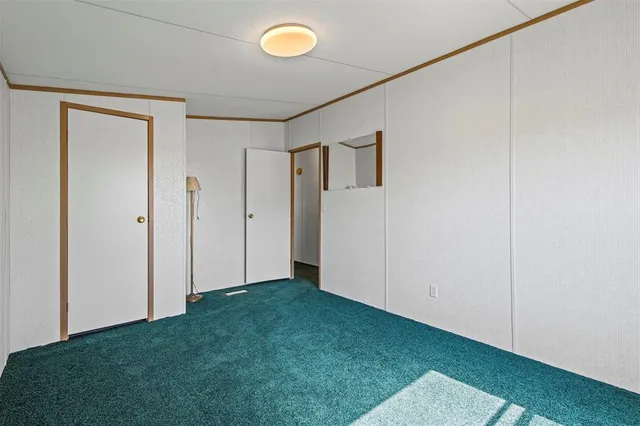a view of an empty room with closet