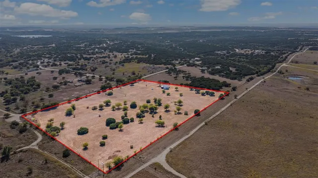 an aerial view of residential house with yard and parking space