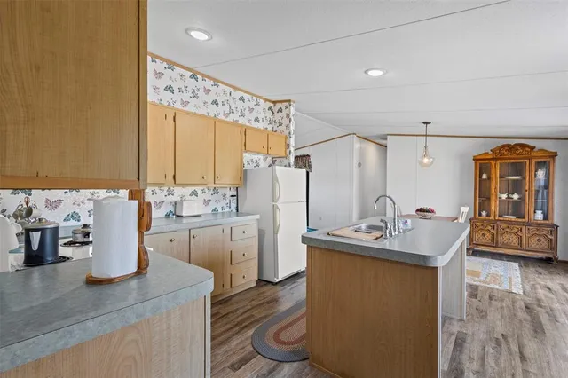 a kitchen with a stove and a wooden cabinets