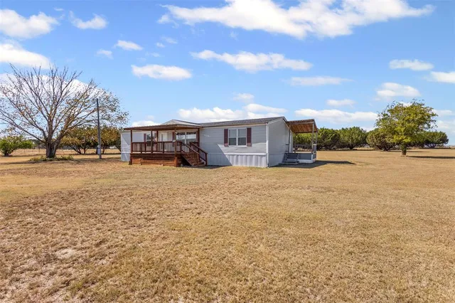 a view of swimming pool with outdoor seating and house in the background