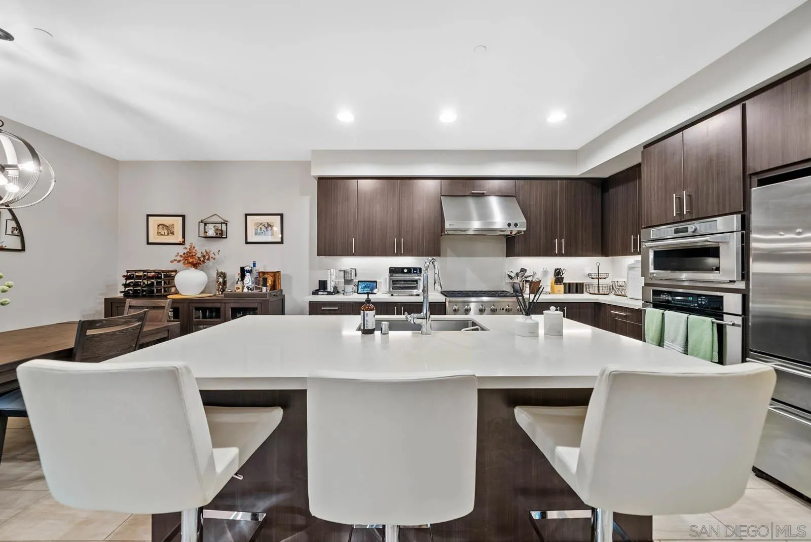 612 Rockefeller Irvine, CA 92612 - Photo 19 of 49 a kitchen with kitchen island a appliances dining table and chairs