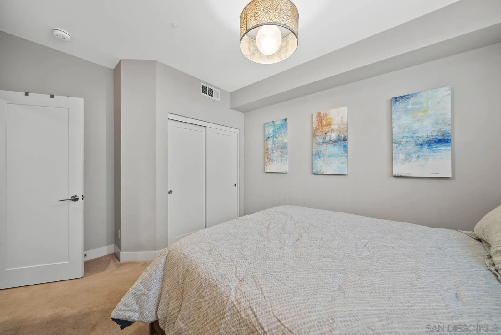 612 Rockefeller Irvine, CA 92612 - Photo 29 of 49 a bedroom with a large bed and a chandelier