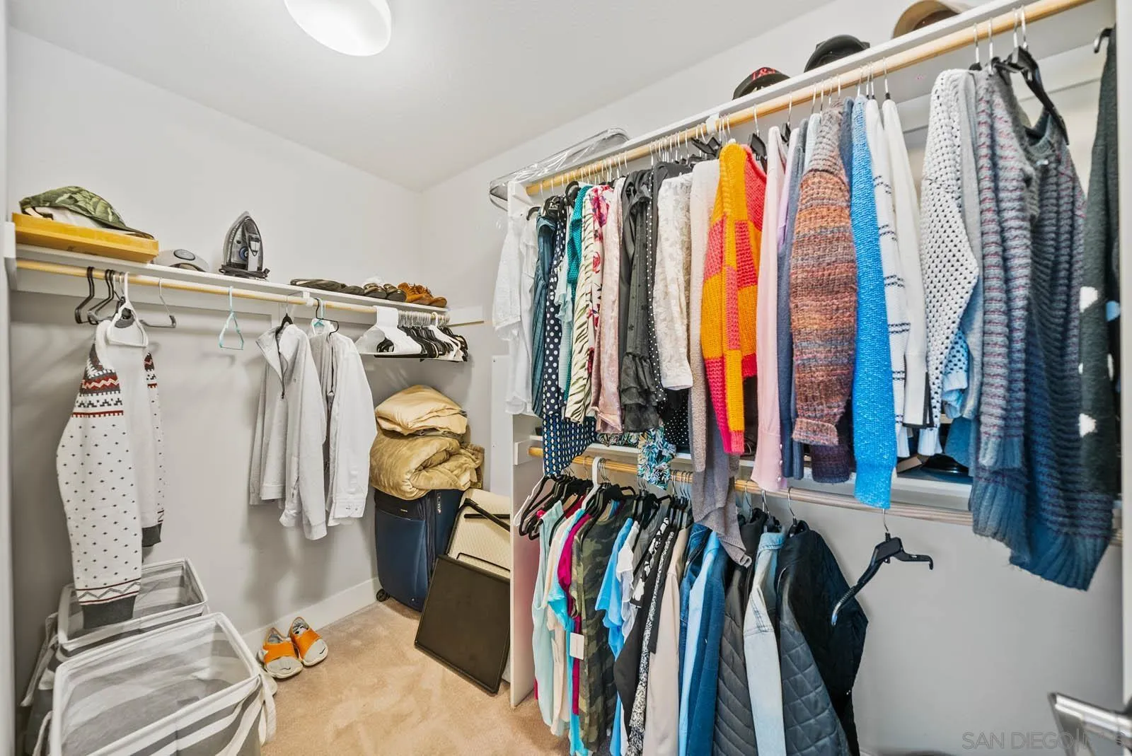 612 Rockefeller Irvine, CA 92612 - Photo 35 of 49 a view of walk in closet with clothes and shoes