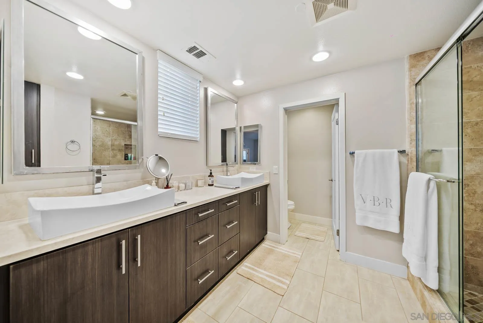 612 Rockefeller Irvine, CA 92612 - Photo 36 of 49 a spacious bathroom with a double vanity sink mirror and shower