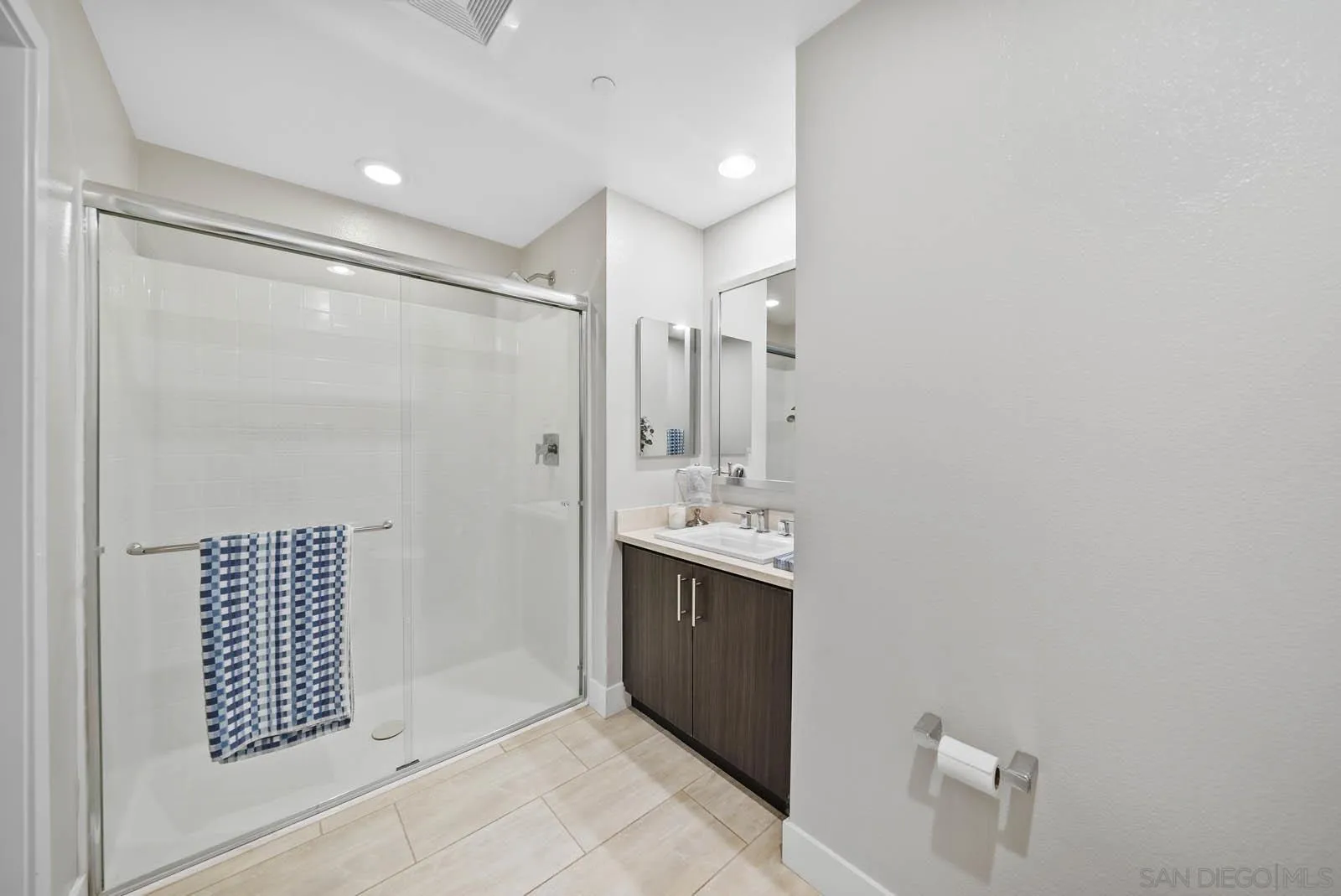 612 Rockefeller Irvine, CA 92612 - Photo 10 of 49 a bathroom with a shower sink and mirror