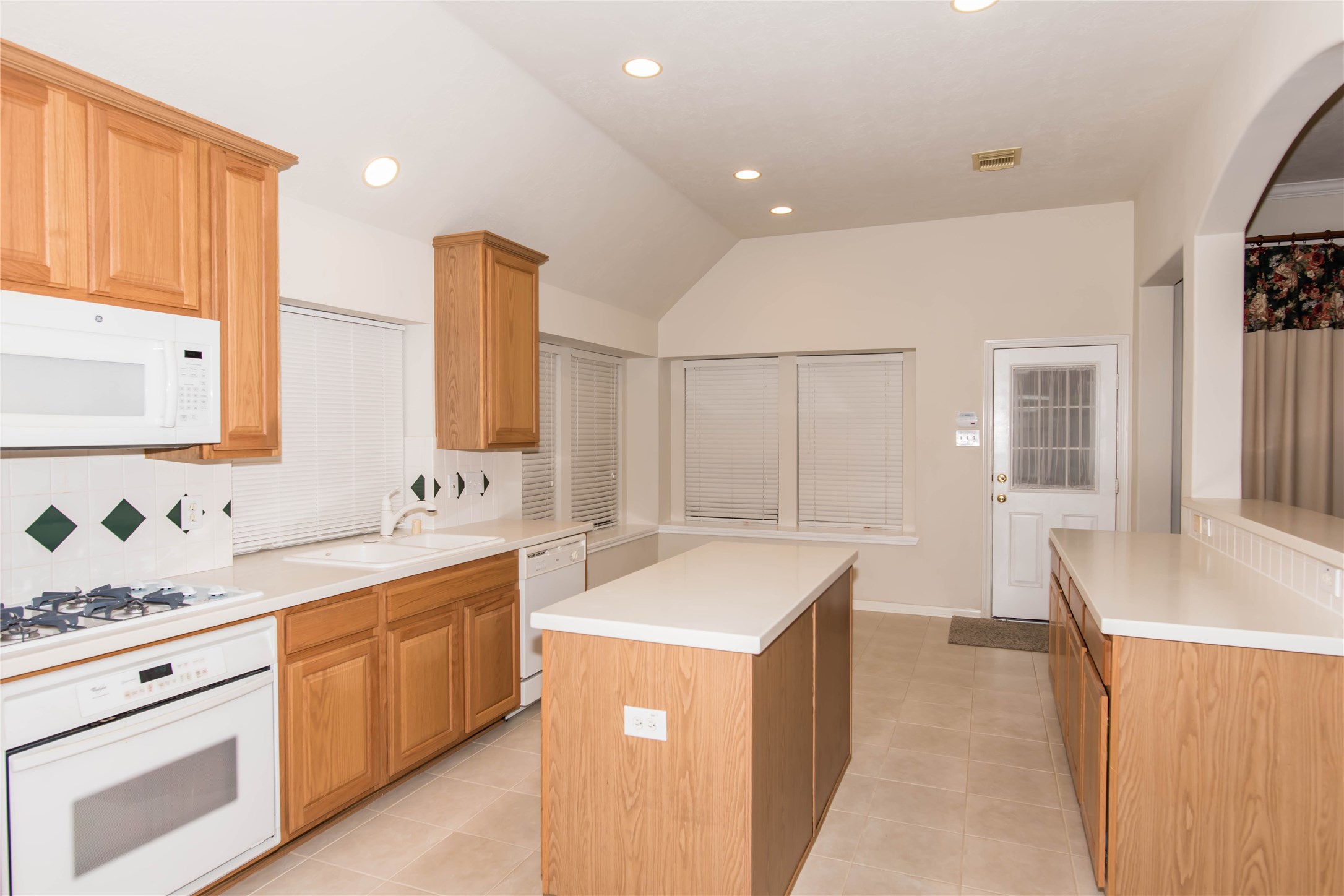 9115 Sunny Ridge Drive Houston, TX 77095 - Photo 11 of 20 a kitchen with a sink stove and cabinets