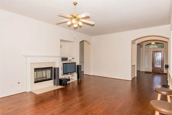a view of a livingroom with a fireplace and wooden floor