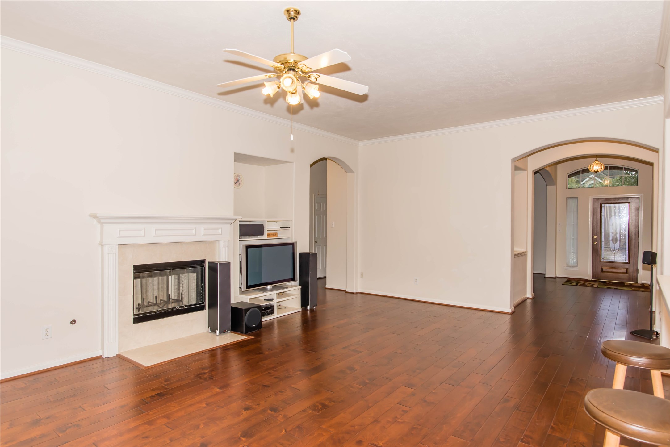 9115 Sunny Ridge Drive Houston, TX 77095 - Photo 5 of 20 a view of a livingroom with a fireplace and wooden floor