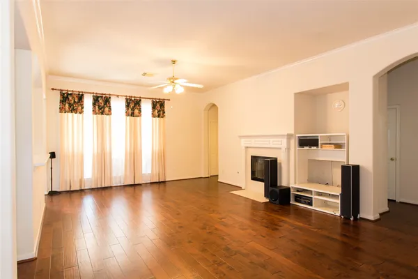 a view of a livingroom with wooden floor and a fireplace