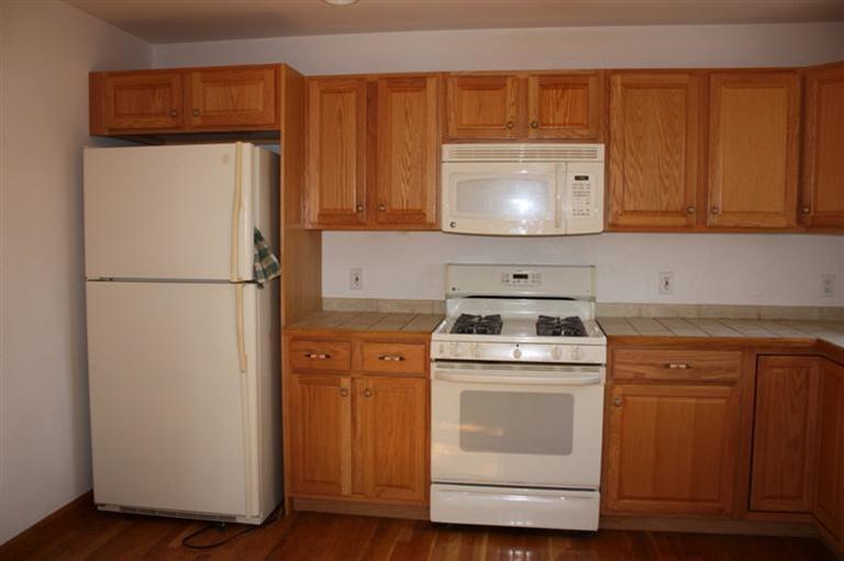 7 Pine Ridge Road Truro, MA 02666 - Photo 4 of 12 a kitchen with a refrigerator sink and cabinets