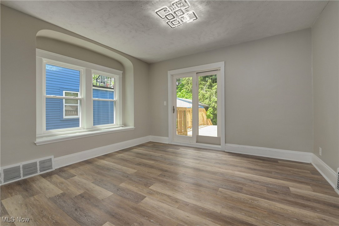 896 Selwyn Road Cleveland Heights, OH 44112 - Photo 17 of 23 Empty room with wood finished floors and a textured ceiling