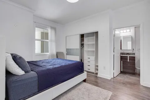 a bedroom with a bed and a window