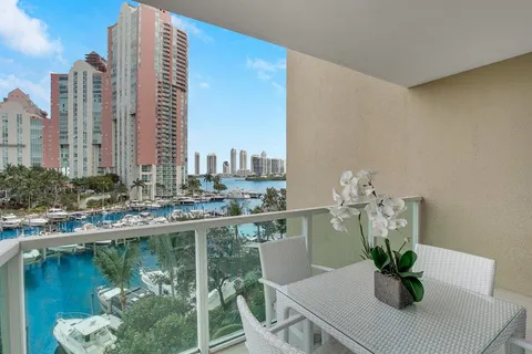 a table with a vase and a chair