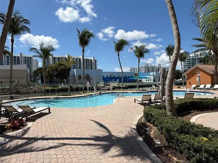 a view of a swimming pool with a table and chairs