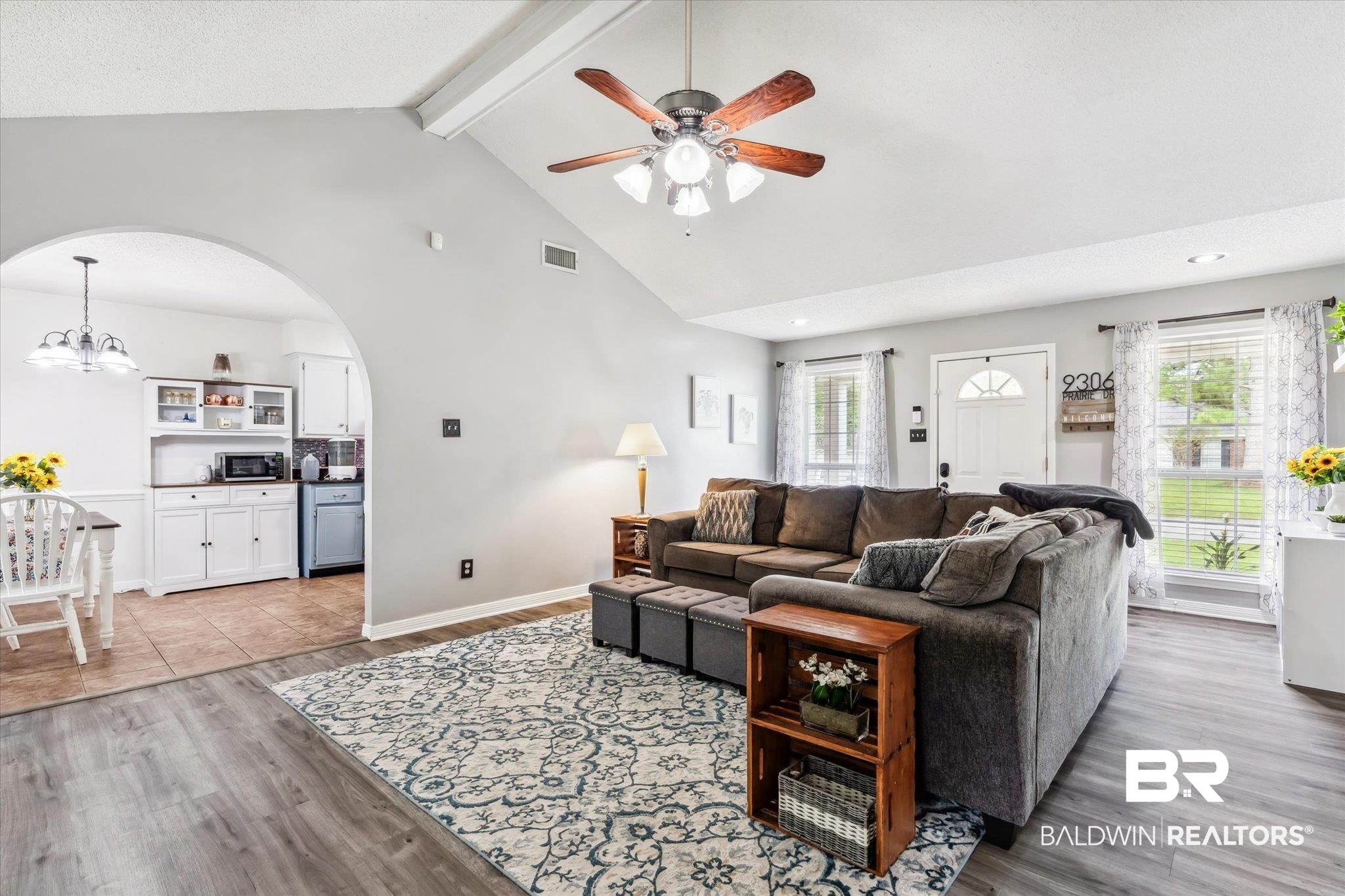 9306 Prairie Drive Semmes, AL 36575 - Photo 3 of 20 Living room featuring high vaulted ceiling, beamed ceiling, light wood-type flooring, and ceiling fan with notable chandelier