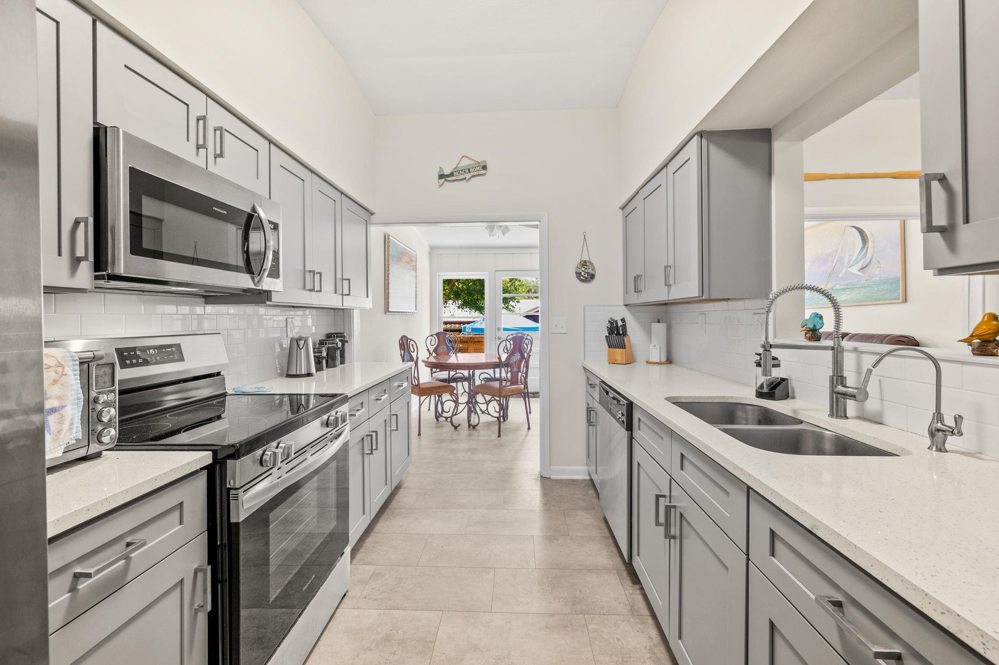 507 Gentian Road St. Augustine, FL 32086 - Photo 12 of 82 a kitchen with stainless steel appliances granite countertop a sink and cabinets