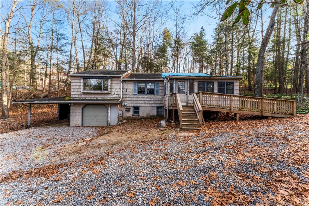 a view of a house with backyard and wooden fence