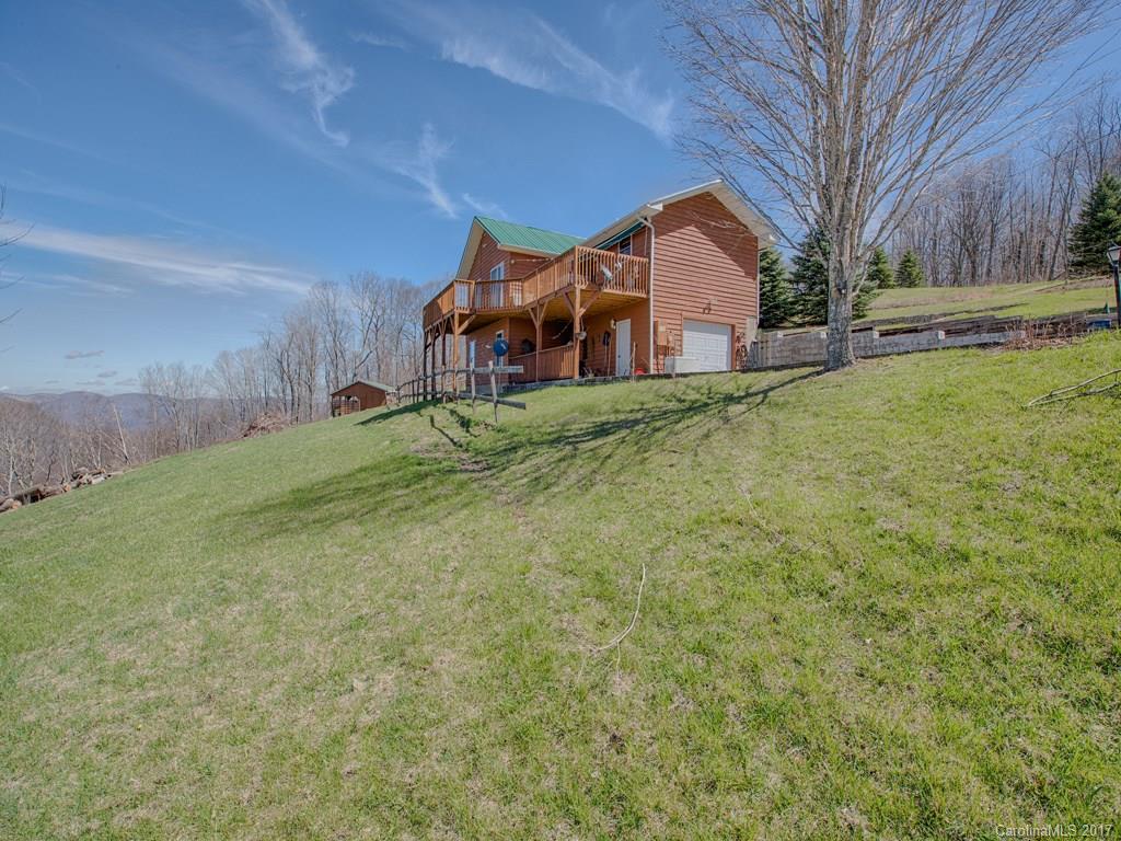 450 Windswept Ridge Road Leicester, NC 28748 - Photo 2 of 18 a front view of a house with a yard