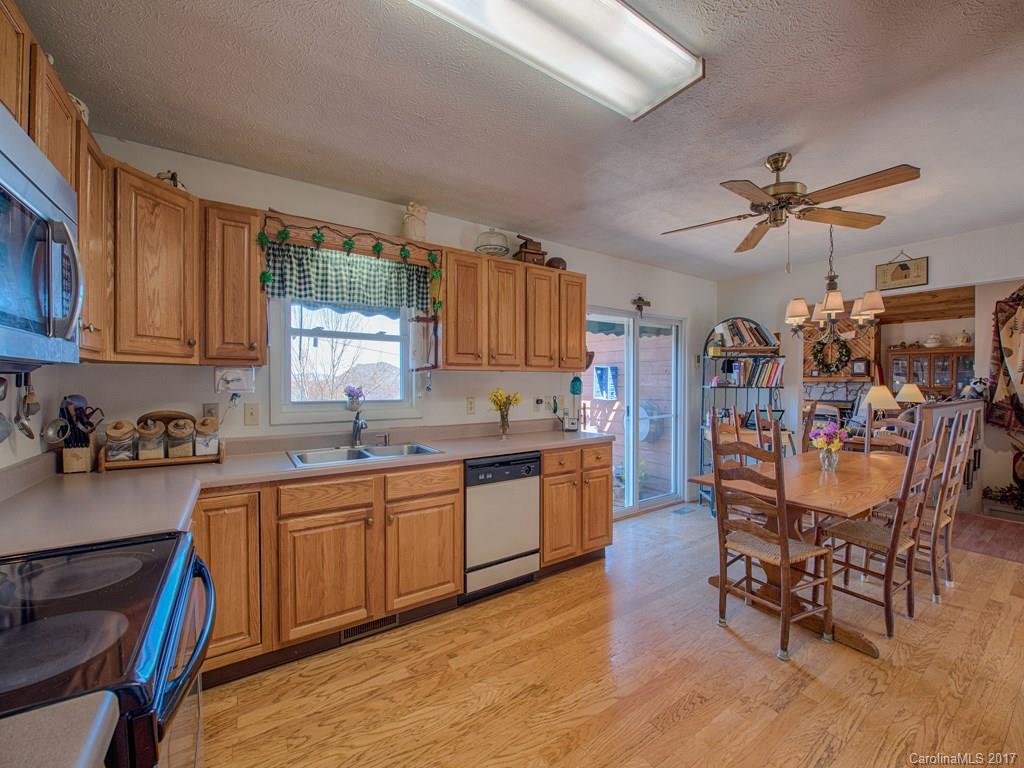 450 Windswept Ridge Road Leicester, NC 28748 - Photo 11 of 18 a large kitchen with a table and chairs in it
