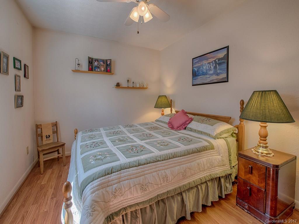 450 Windswept Ridge Road Leicester, NC 28748 - Photo 14 of 18 a bedroom with a bed a baby desk and chair