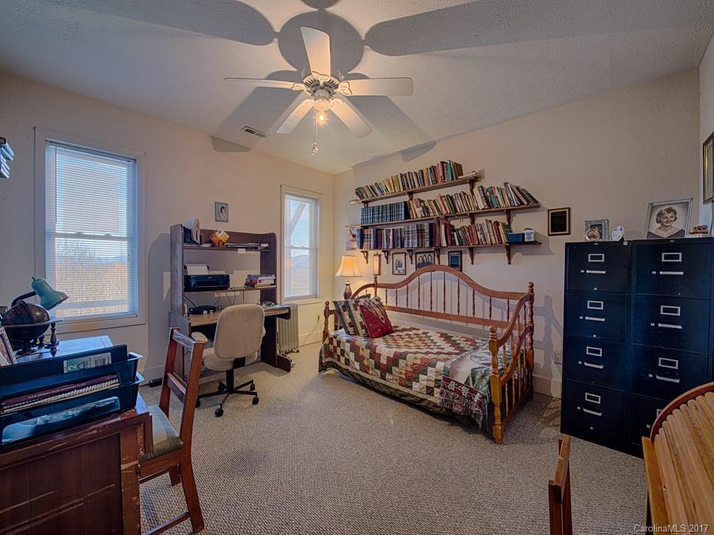 450 Windswept Ridge Road Leicester, NC 28748 - Photo 17 of 18 a bedroom with a bed window and a chandelier