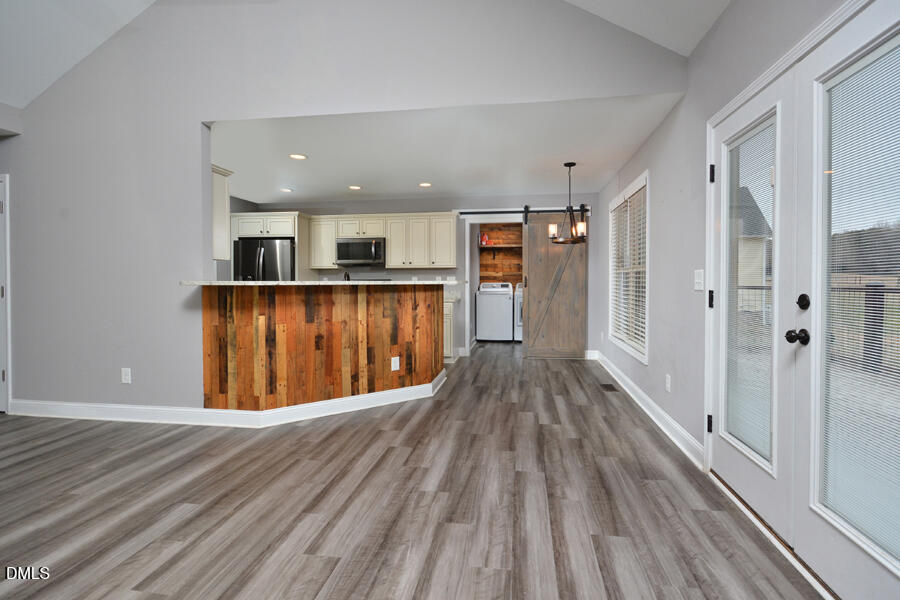 3082 East Thollie Green Road Stem, NC 27581 - Photo 11 of 45 a view of a kitchen with wooden floor