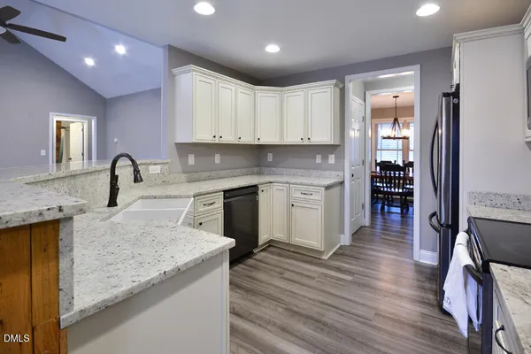 a kitchen with white cabinets and a sink