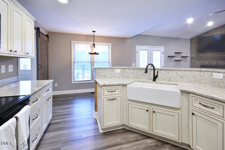 3082 East Thollie Green Road Stem, NC 27581 - Photo 16 of 45 a kitchen with white cabinets and a sink