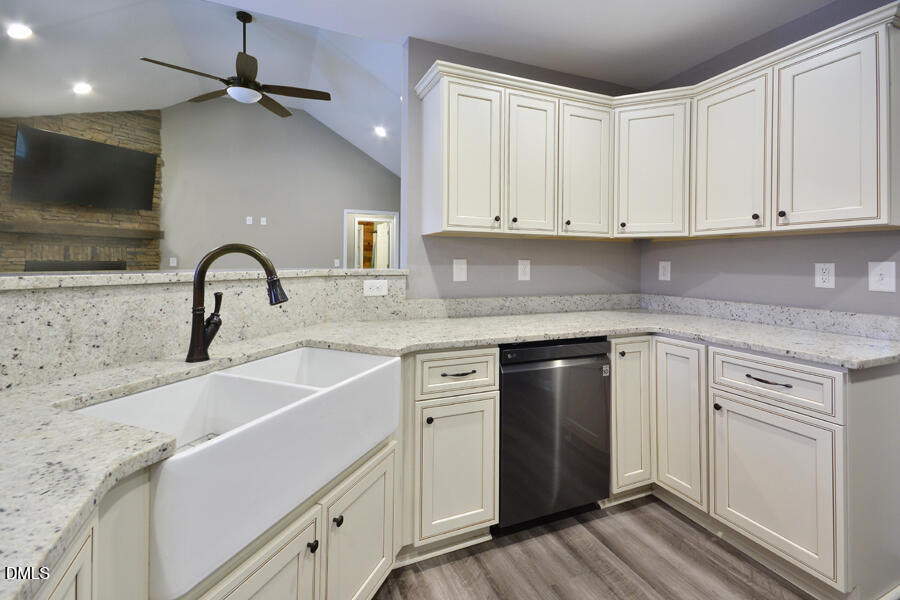 3082 East Thollie Green Road Stem, NC 27581 - Photo 17 of 45 a kitchen with granite countertop a sink stainless steel appliances and cabinets