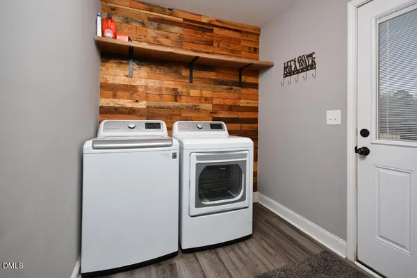 a view of kitchen with cabinets stainless steel appliances and wooden floor