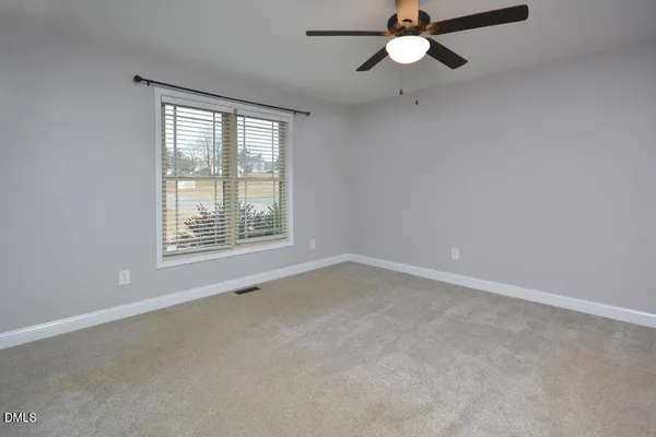 a bedroom with a bed and a dresser in it