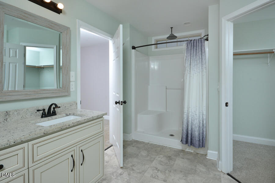3082 East Thollie Green Road Stem, NC 27581 - Photo 28 of 45 a bathroom with a sink and a mirror