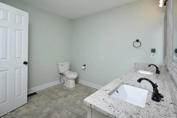 an empty room with a window and a ceiling fan