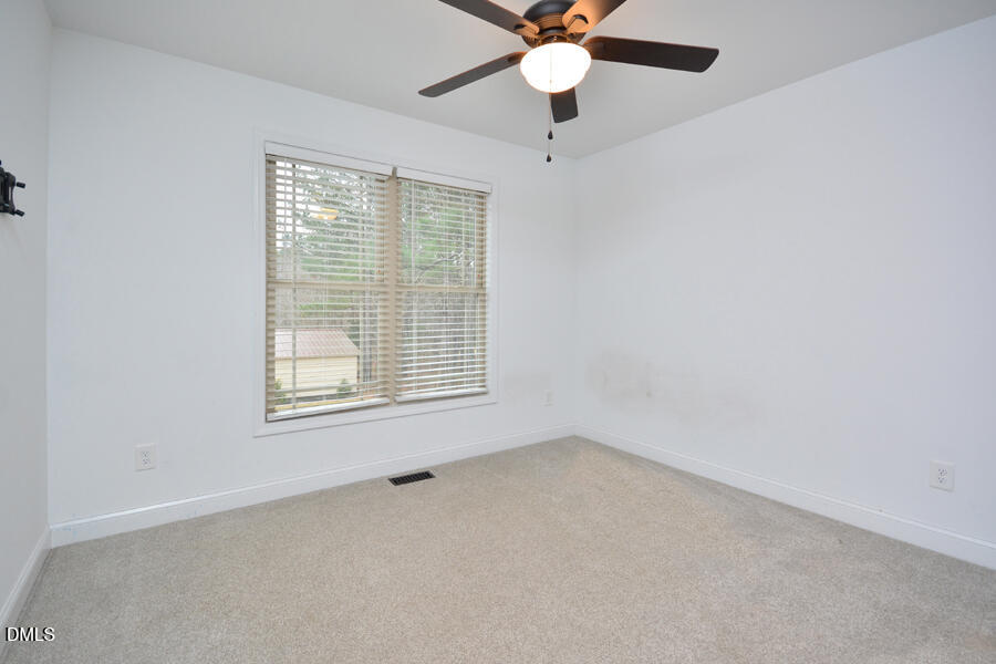 3082 East Thollie Green Road Stem, NC 27581 - Photo 32 of 45 an empty room with a window and a fan