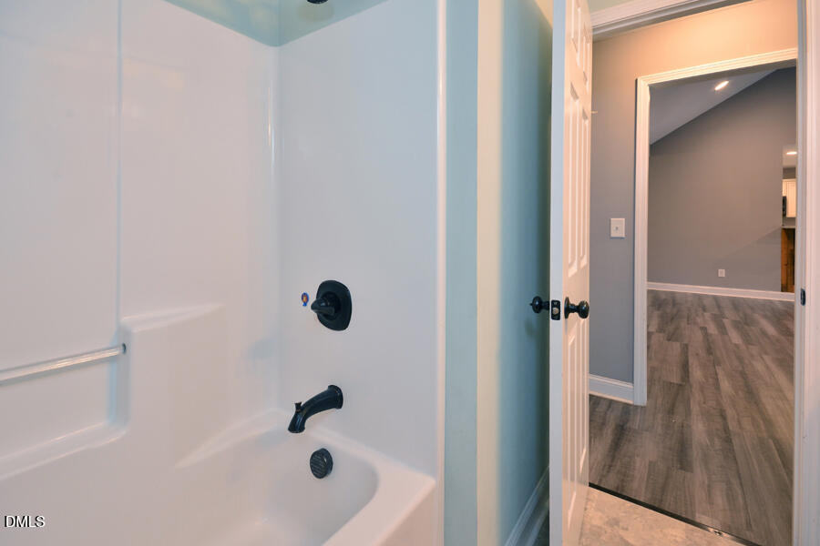 3082 East Thollie Green Road Stem, NC 27581 - Photo 34 of 45 a bathroom with a tub